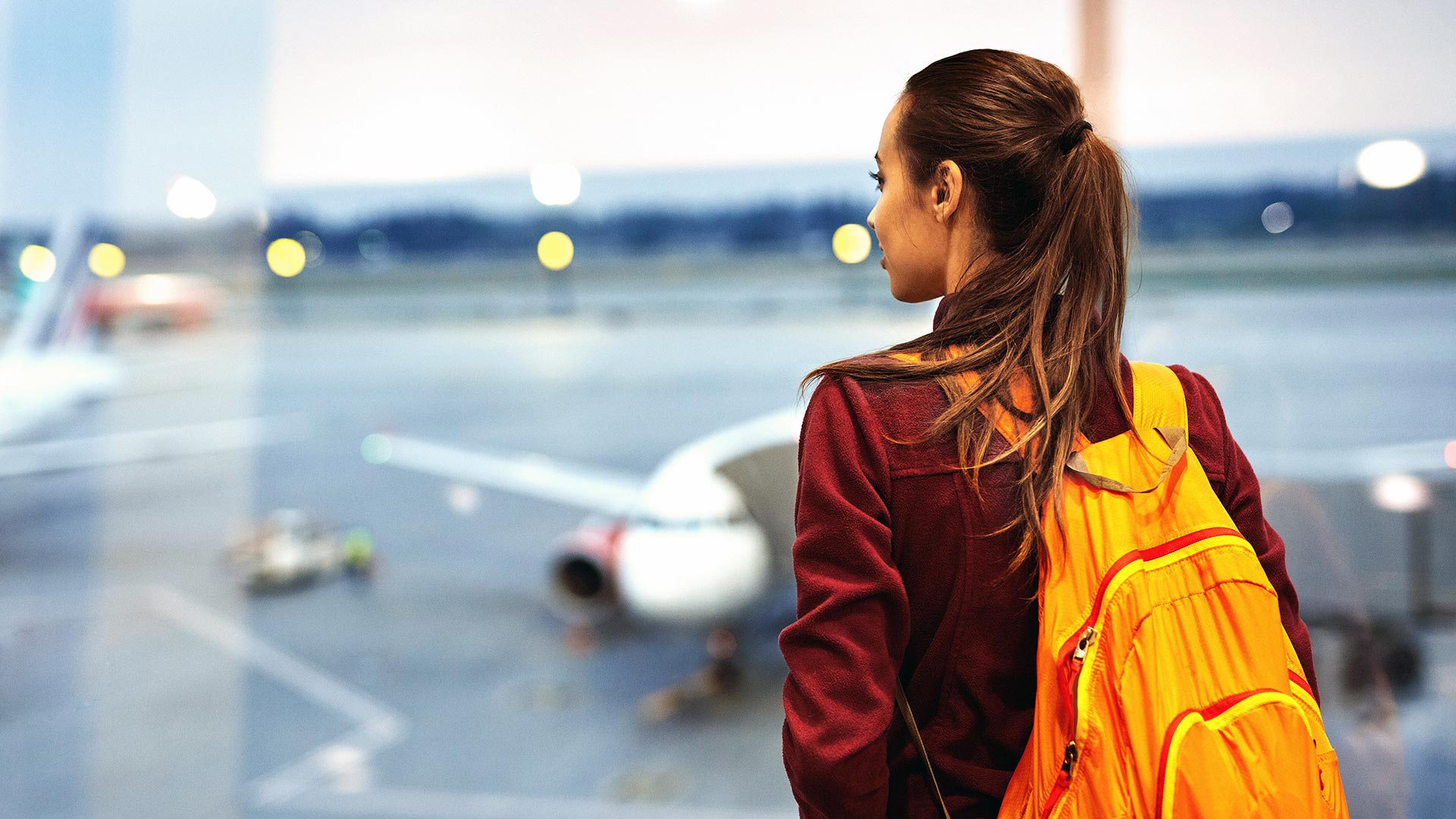 A woman surveys airplanes at an airport