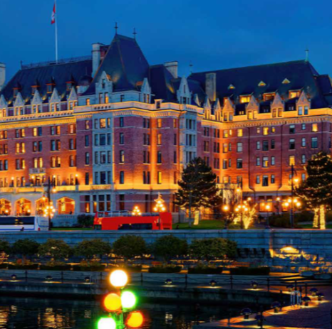 a beautiful building is decked out in christmas lights in victoria canada