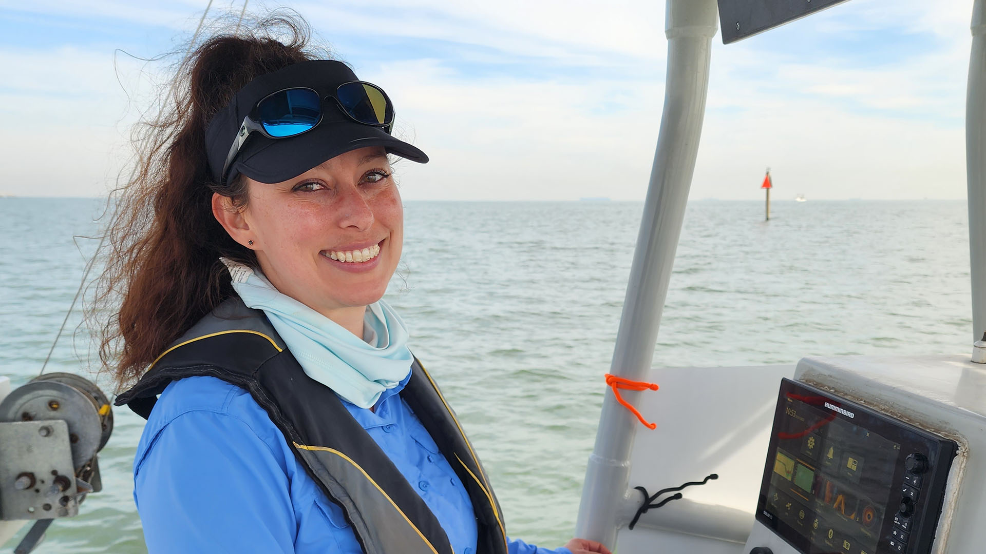 Sherah McDaniel Sherah, smiling at the camera, is on a boat with the ocean horizon in the background.