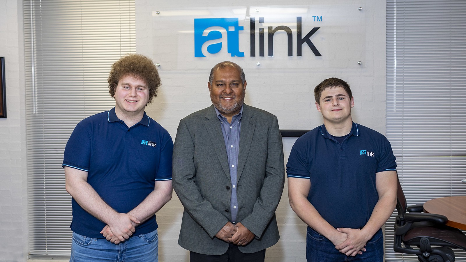 UHCL alumnus Dilhar De Silva, center, offers hands-on experience and training to upcoming IT specialists like Ryan Brooker, left, and Joseph Bittinger