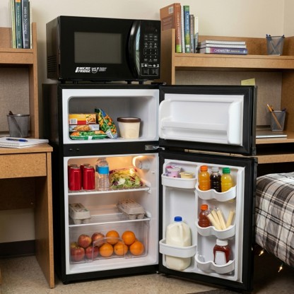 MicroFridge Unit image MicroFridge Unit image depicting an open fridge and freezer that includes food, drinks, and a microwave